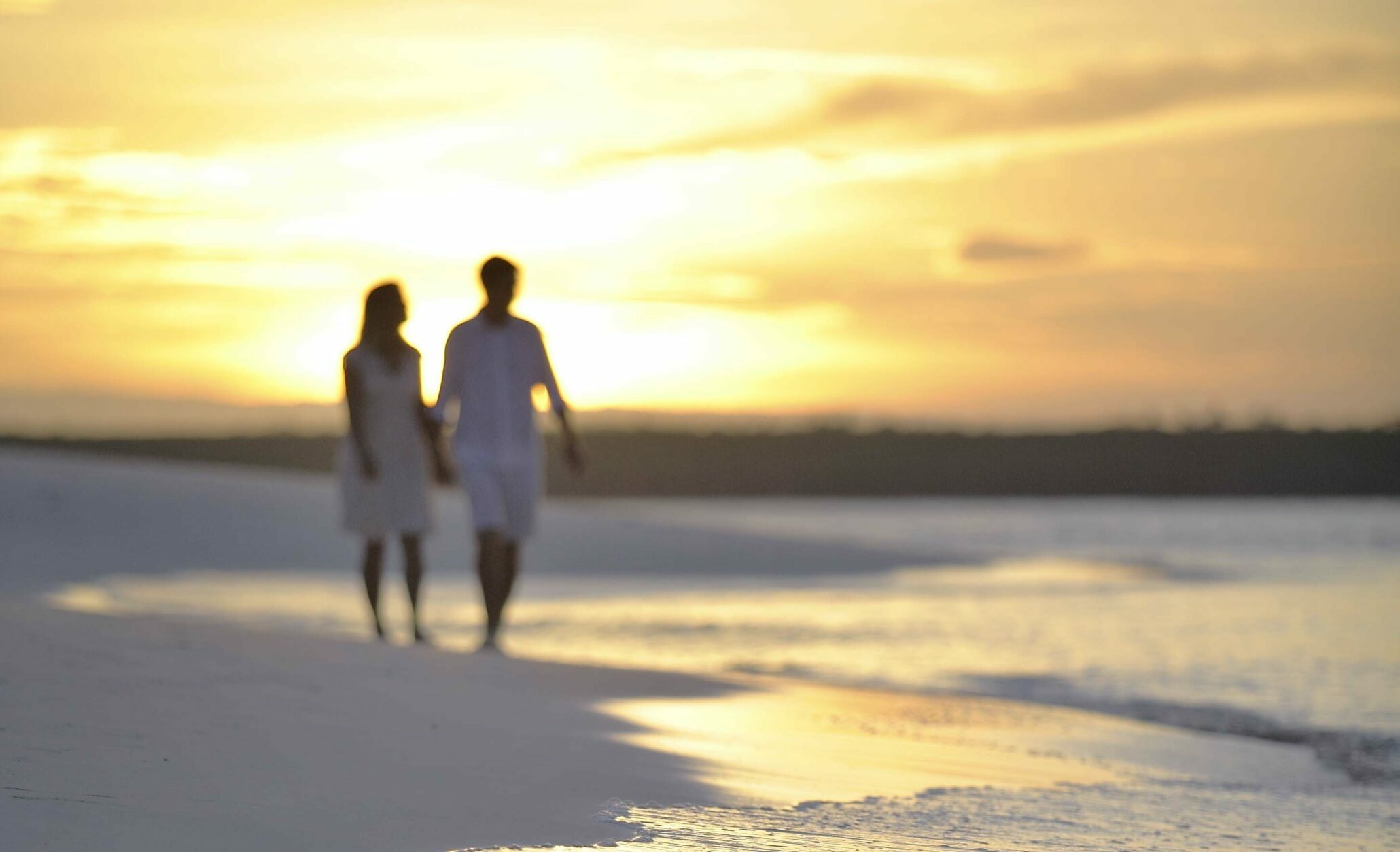 couple walking mnemba island Zanzibar sunset